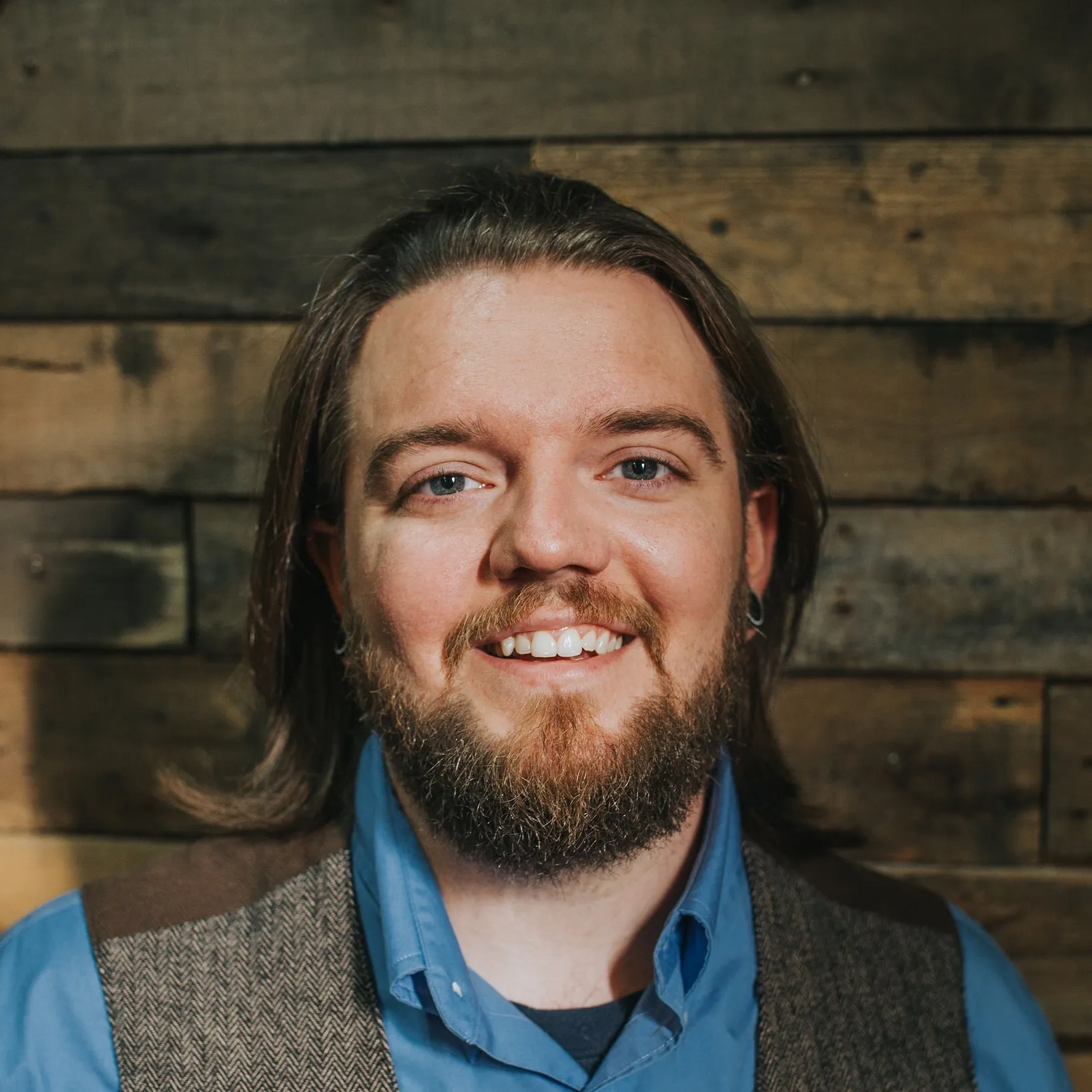 Travis Windsor-Cummings, photographed against a wood-plank wall